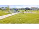 Community playground with a swing set, slide, climbing structures, and open grassy area at 8635 Verbena Rd, Zionsville, IN 46077