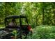 An ATV rider enjoying lush green trails surrounded by trees and foliage at 8717 Moore Rd, Indianapolis, IN 46278