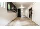 Unfinished basement with painted white block walls and black cabinet storage provides ample opportunity for customization at 8717 Moore Rd, Indianapolis, IN 46278