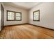 Light-filled bedroom featuring hardwood floors and two large windows at 8717 Moore Rd, Indianapolis, IN 46278