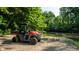 Polaris Ranger utility vehicle parked near the riverbank, surrounded by lush greenery and mature trees on a sunny day at 8717 Moore Rd, Indianapolis, IN 46278