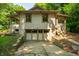 Unique two-story home featuring a basement garage and inviting covered porch at 8717 Moore Rd, Indianapolis, IN 46278