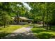 Charming home featuring stone accents, covered porch, and long driveway at 8717 Moore Rd, Indianapolis, IN 46278