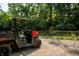 Polaris Ranger utility vehicle parked near the riverbank, surrounded by lush greenery and mature trees on a sunny day at 8717 Moore Rd, Indianapolis, IN 46278