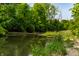 Scenic river view featuring clear water, lush greenery, and a serene natural environment on a sunny day at 8717 Moore Rd, Indianapolis, IN 46278