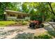 Charming ranch home with a covered porch, stone accents, a gravel driveway and a Polaris Ranger utility vehicle at 8717 Moore Rd, Indianapolis, IN 46278