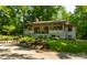 Charming home with covered porch, concrete steps, and professional landscaping at 8717 Moore Rd, Indianapolis, IN 46278