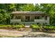 Charming home with a covered porch, featuring concrete steps and manicured landscaping at 8717 Moore Rd, Indianapolis, IN 46278
