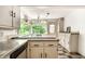 Charming kitchen featuring colorful tile floors, classic cabinetry, and a view of the greenery at 8717 Moore Rd, Indianapolis, IN 46278