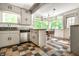 Charming kitchen featuring colorful tile floors, bright natural light, and classic cabinetry at 8717 Moore Rd, Indianapolis, IN 46278