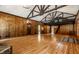 Grand living room features a loft, wood paneling, hardwood floors and lots of space at 8717 Moore Rd, Indianapolis, IN 46278