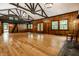 Open living room with wood floors, wood paneled walls, and access to a loft area at 8717 Moore Rd, Indianapolis, IN 46278