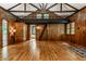 Unique living room with wood-paneled walls, hardwood floors, a loft, and bright windows at 8717 Moore Rd, Indianapolis, IN 46278