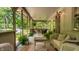 Inviting covered porch featuring comfortable seating and view of the wooded lot at 8717 Moore Rd, Indianapolis, IN 46278
