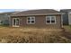 New construction home featuring brown siding and a sliding door in backyard at 10132 Redwood Peak Ln, Indianapolis, IN 46259