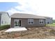 Newly constructed home features a small concrete patio and dark brown vinyl siding at 10132 Redwood Peak Ln, Indianapolis, IN 46259