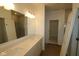 A bathroom with a double vanity, framed mirror, and tiled shower, offers an elegant and functional space at 10132 Redwood Peak Ln, Indianapolis, IN 46259