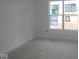 An unfinished bedroom with a large window, and neutral paint at 10132 Redwood Peak Ln, Indianapolis, IN 46259
