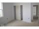 An unfinished bedroom with an ensuite bathroom, large windows, and neutral paint at 10132 Redwood Peak Ln, Indianapolis, IN 46259