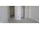 Bright bedroom with an unfinished floor, closet, and white doors at 10132 Redwood Peak Ln, Indianapolis, IN 46259