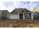 Charming new construction home featuring a covered porch and an attached two-car garage at 10132 Redwood Peak Ln, Indianapolis, IN 46259