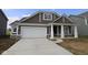 Charming single-Gathering home featuring brown siding, stone accents, and a spacious two-car garage at 10132 Redwood Peak Ln, Indianapolis, IN 46259
