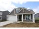 Beautiful home exterior showcasing neutral siding, white trim, and well-maintained landscaping at 10132 Redwood Peak Ln, Indianapolis, IN 46259