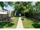 Serene backyard with mature trees, green grass, and a charming garden at 1021 N Alabama St, Indianapolis, IN 46202