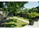 Inviting backyard with a pathway, lush grass, and a blue shed, offering a serene outdoor space at 1021 N Alabama St, Indianapolis, IN 46202