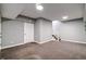 Finished basement with neutral carpet, gray walls, and a staircase at 1021 N Alabama St, Indianapolis, IN 46202
