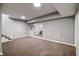 Spacious basement with a carpeted floor and an updated staircase at 1021 N Alabama St, Indianapolis, IN 46202