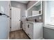 Bathroom with double vanity, marble countertop, modern fixtures, and illuminated mirror at 1021 N Alabama St, Indianapolis, IN 46202