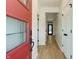 Bright entryway featuring a red front door, sleek hardwood floors, and white trim throughout at 1021 N Alabama St, Indianapolis, IN 46202