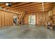 Unfinished garage space with wood framing, concrete flooring, and garage door mechanism visible at 1021 N Alabama St, Indianapolis, IN 46202