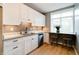 Modern kitchen featuring white cabinetry, granite countertops, stainless steel appliances, and a cozy breakfast nook at 1021 N Alabama St, Indianapolis, IN 46202