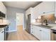 Contemporary kitchen showcasing white cabinets, stainless steel appliances, granite counters, and hardwood flooring at 1021 N Alabama St, Indianapolis, IN 46202