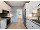 Well-equipped kitchen with white cabinets, stainless steel appliances, granite counters, and a view to the living area at 1021 N Alabama St, Indianapolis, IN 46202