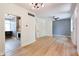 Inviting living room boasting hardwood floors, neutral paint, and modern lighting with a seamless transition to the kitchen at 1021 N Alabama St, Indianapolis, IN 46202