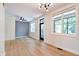 Light-filled living room boasting hardwood floors, fresh white walls, and a modern ceiling fan and lighting at 1021 N Alabama St, Indianapolis, IN 46202