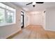 Bright living room featuring hardwood floors, large windows, modern lighting, and a view to the outdoors at 1021 N Alabama St, Indianapolis, IN 46202