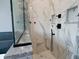 A walk-in shower is tiled with marble and features multiple shower heads and built-in shelving at 1021 N Alabama St, Indianapolis, IN 46202