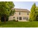 A well-maintained backyard with lush lawn, complemented by a concrete patio and mature trees, perfect for outdoor relaxation at 10248 Noble Ct, Indianapolis, IN 46234