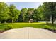 Lush backyard with expansive green lawn, mature trees, and a playhouse for outdoor enjoyment at 10248 Noble Ct, Indianapolis, IN 46234