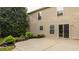 Home's backyard features a concrete patio, vinyl siding, well-maintained lawn and lush landscaping at 10248 Noble Ct, Indianapolis, IN 46234