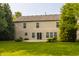 The home's backyard features a concrete patio, vinyl siding, lawn and green landscaping at 10248 Noble Ct, Indianapolis, IN 46234