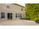 Home's backyard features a concrete patio, vinyl siding, well-maintained lawn and lush landscaping at 10248 Noble Ct, Indianapolis, IN 46234