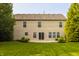 The home's backyard features a concrete patio, vinyl siding, lawn and green landscaping at 10248 Noble Ct, Indianapolis, IN 46234