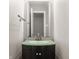 Bathroom featuring vanity with glass countertop, modern faucet and a large mirror at 10248 Noble Ct, Indianapolis, IN 46234
