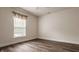 Bedroom with a ceiling fan, light walls, and dark wood-like flooring at 10248 Noble Ct, Indianapolis, IN 46234