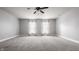 Spacious carpeted bedroom with a ceiling fan and two windows at 10248 Noble Ct, Indianapolis, IN 46234